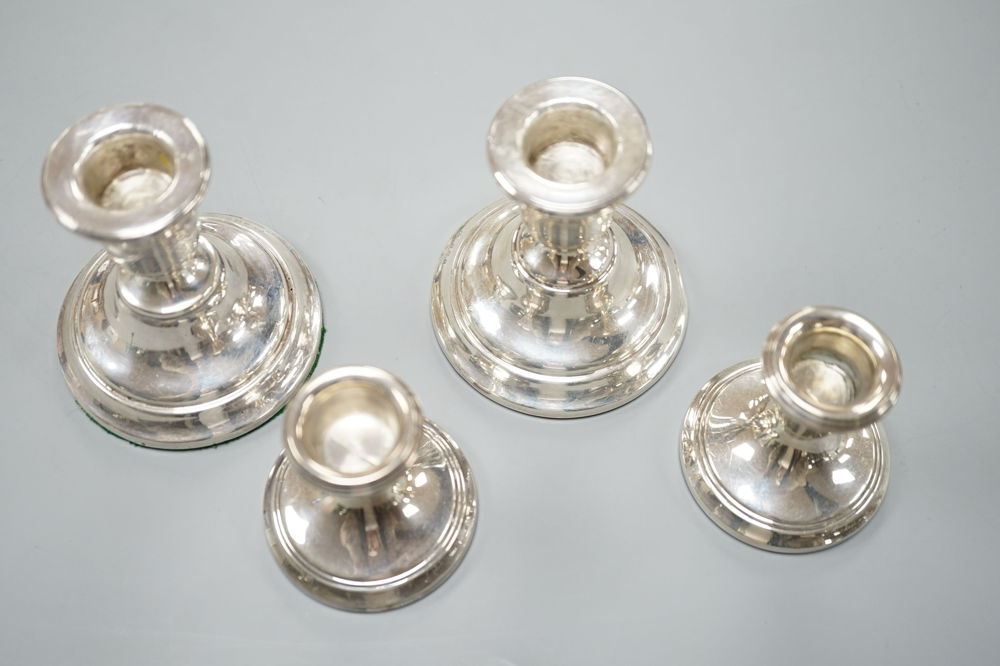 Two pairs of modern silver mounted dwarf candlesticks, tallest 84mm.